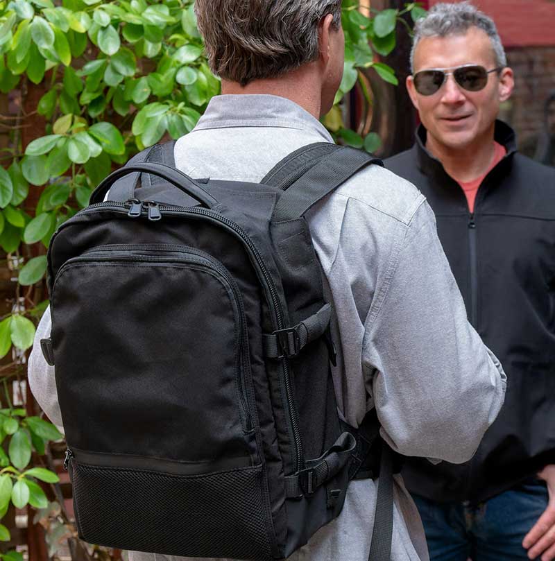 Two men talking wearing bullet proof backpack by BodyGuard